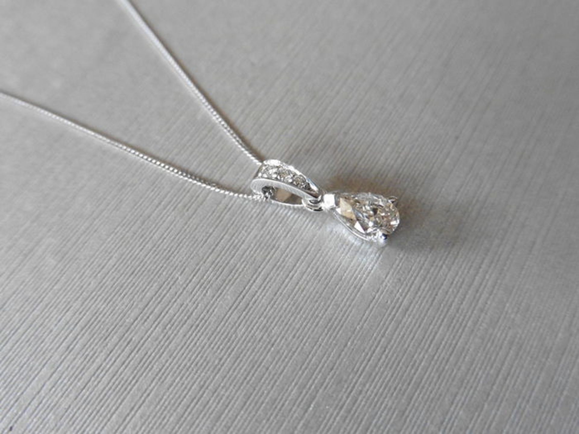 0.40ct pear shaped solitaire pendant set in platinum. J colour, si2 clarity. Diamond set bale and - Image 2 of 3