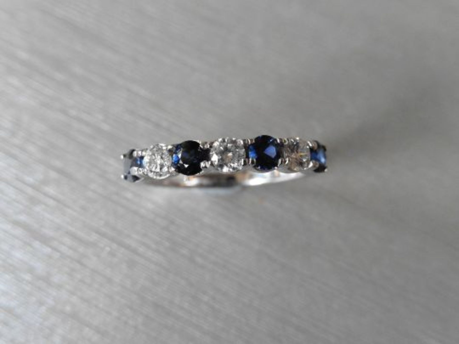 Sapphire and diamond eternity style ring. 4 round cut sapphires ( treated) 3 brilliant cut diamonds. - Image 3 of 3