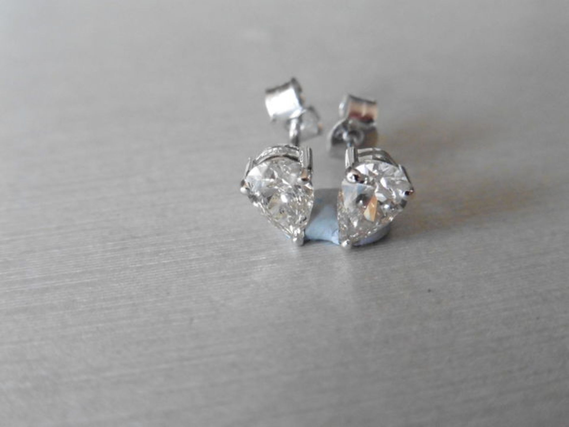 0.70ct diamond earrings set with pear shaped diamonds, I/J colour, si2 clarity. 3 claw setting in