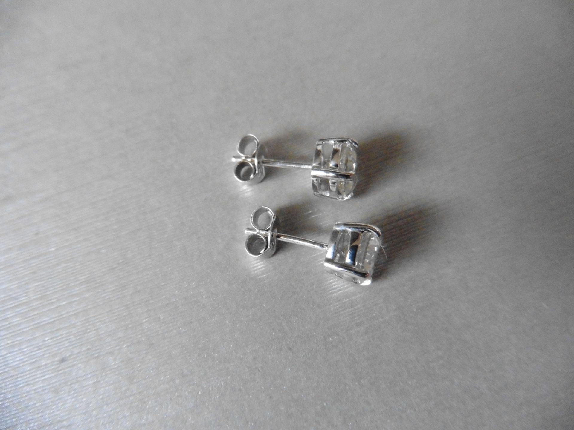 2.00ct Solitaire diamond stud earrings set with brilliant cut diamonds which have been enhanced. H/I - Image 2 of 2
