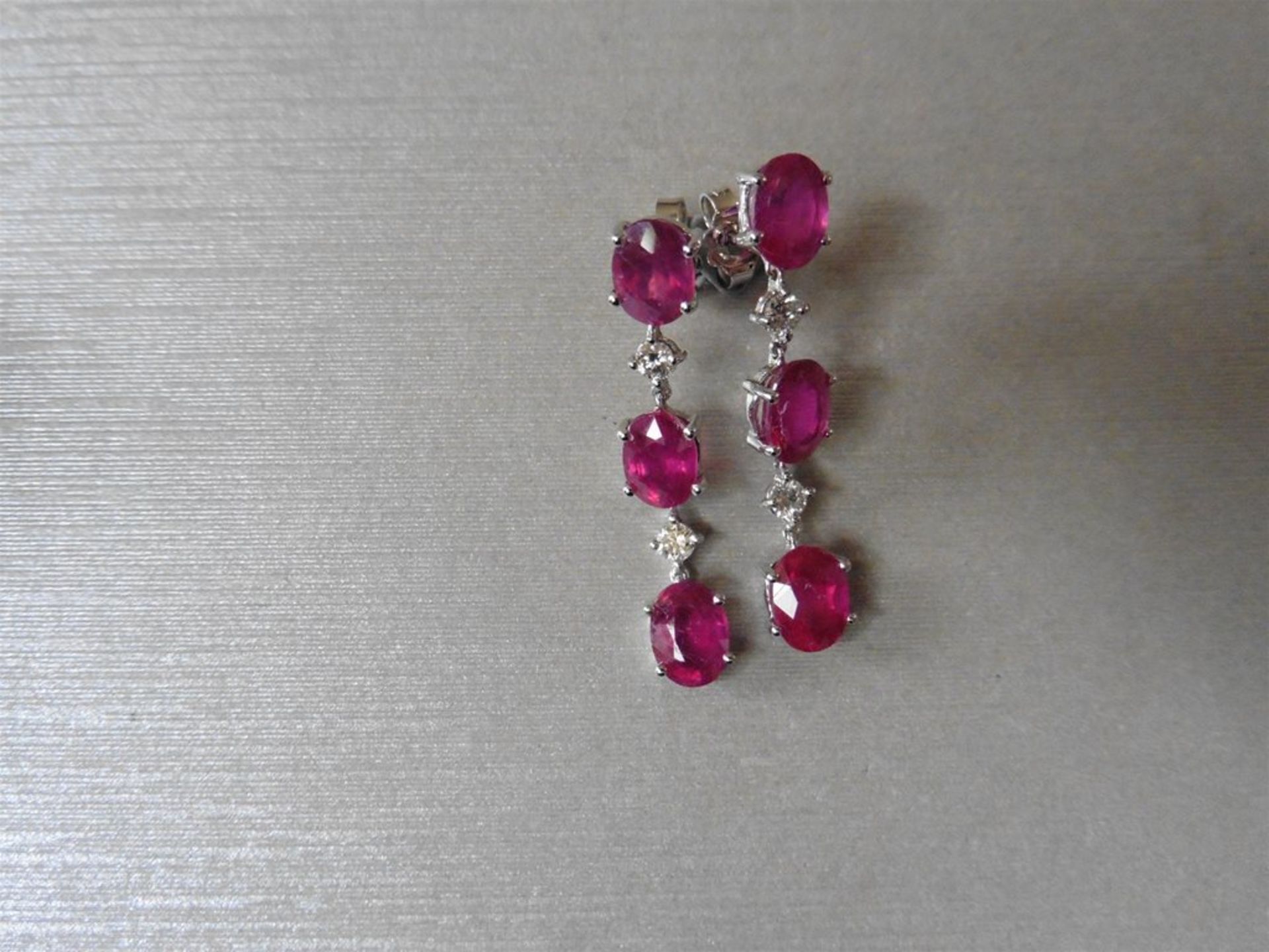 4.80ct ruby and diamond drop earrings. Each set with 3 oval cut rubies ( glass filled ) and 2 brilli