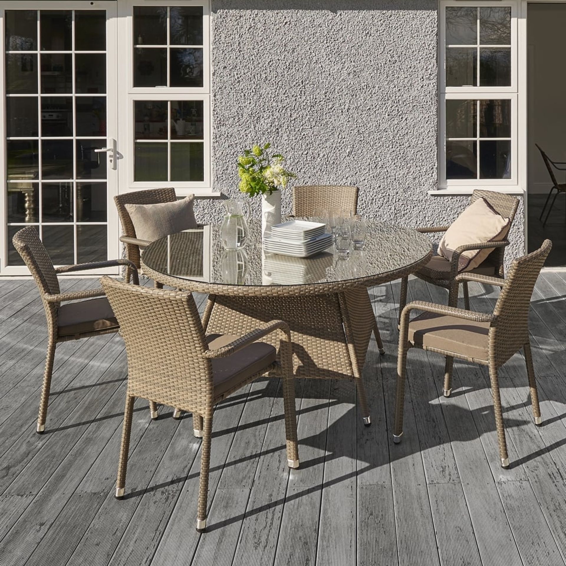 The Edinburgh rattan dining set in taupe consists of 6 stackable dining arm chairs with seat