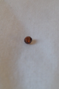 Redish brown ball cut diamond around 0.25ct. Not sure of the clarity and no certification.