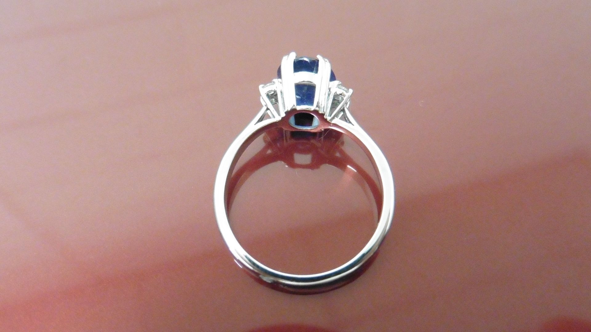 2.40ct Sapphire and diamond dress ring. Oval cut ( glass filled ) sapphire with 2 small brilliant - Image 3 of 4