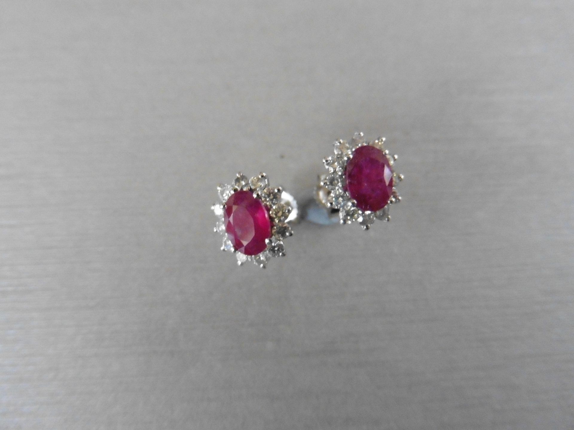 1.60ct ruby and Diamond cluster style stud earrings. Each ruby ( glass filled ) measures 7mm x 5mm