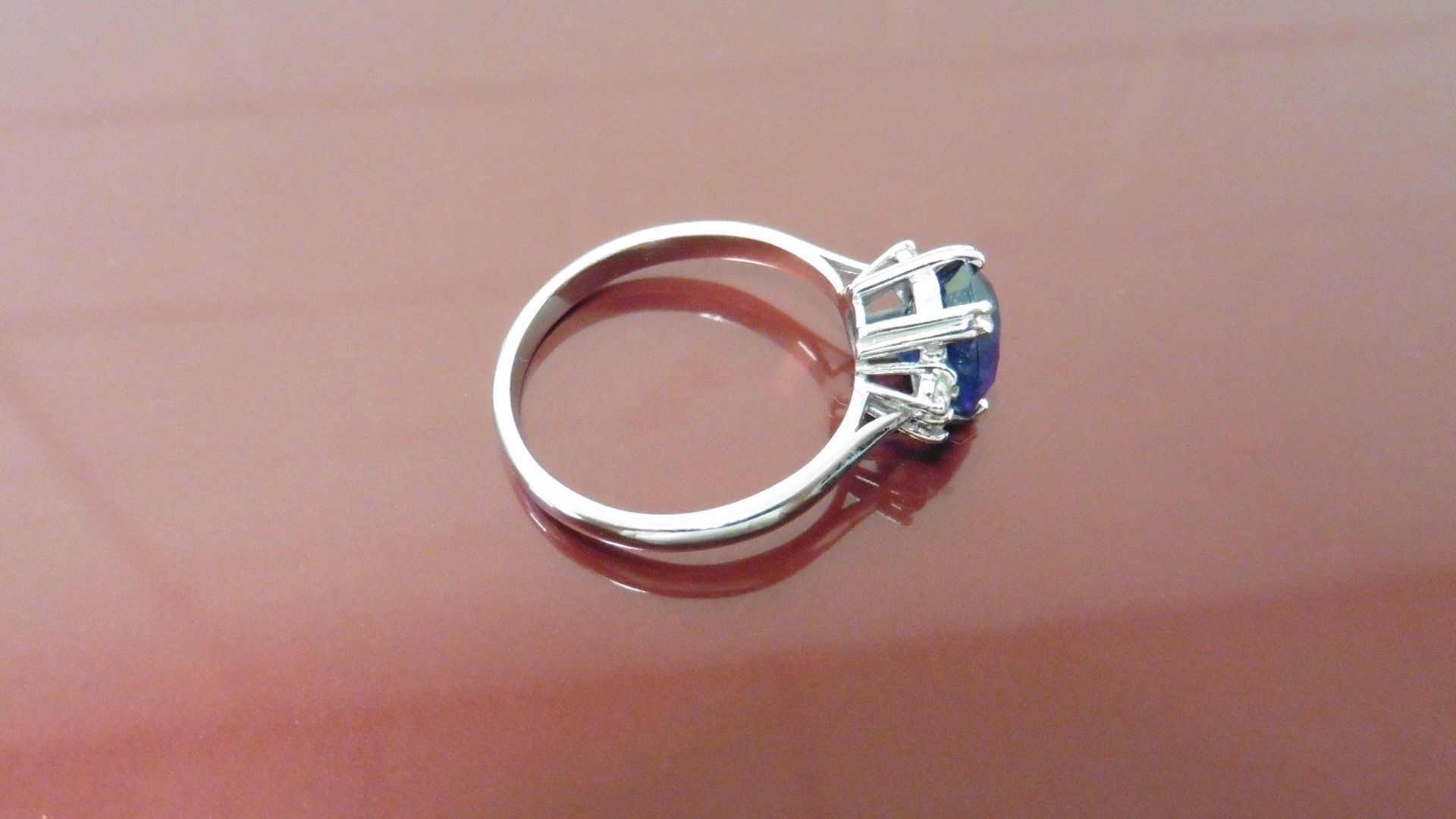 2.40ct Sapphire and diamond dress ring. Oval cut ( glass filled ) sapphire with 2 small brilliant - Image 2 of 4