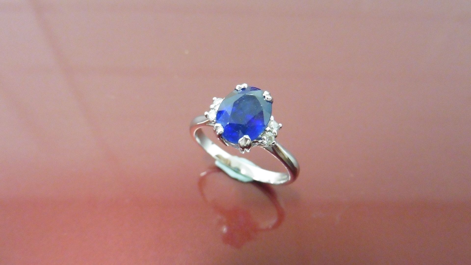 2.40ct Sapphire and diamond dress ring. Oval cut ( glass filled ) sapphire with 2 small brilliant - Image 4 of 4