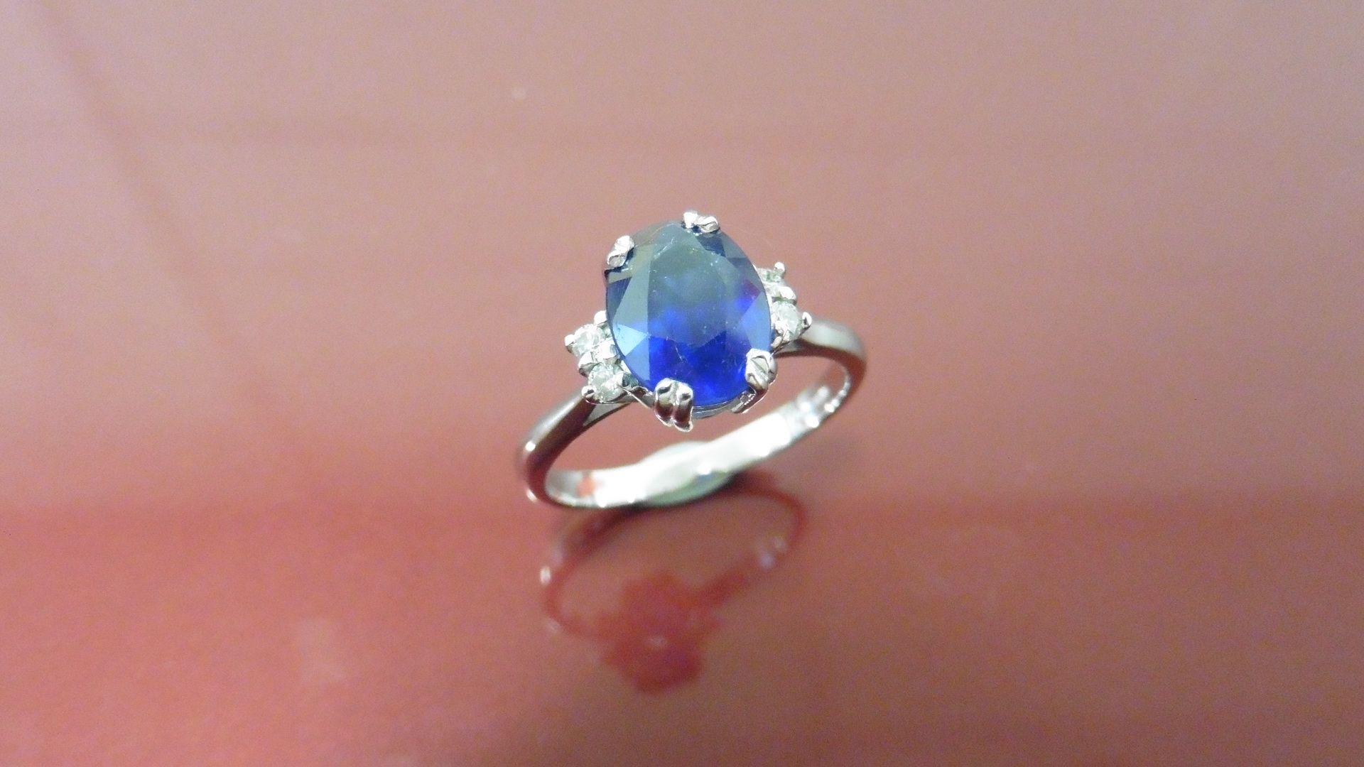 2.40ct Sapphire and diamond dress ring. Oval cut ( glass filled ) sapphire with 2 small brilliant