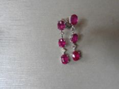 4.80ct ruby and diamond drop earrings. Each set with 3 oval cut rubies ( glass filled ) and 2