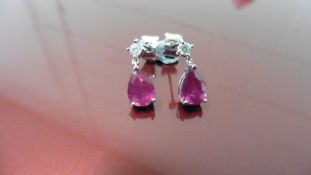 0.70ct drop style earrings. Each set with a pear shaped ruby ( glass filled ) and a small