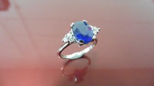 2.40ct Sapphire and diamond dress ring. Oval cut ( glass filled ) sapphire with 3 small brilliant