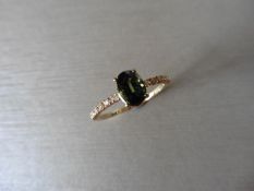 0.80ct / 0.12ct green sapphire and diamond dress ring. Oval cut ( treated ) sapphire with small