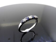 0.40ct sapphire and diamond eternity style ring. Set with 4 round cut sapphires and 3 diamonds. Size