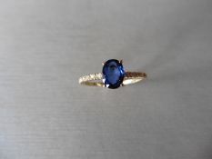 0.80ct / 0.12ct sapphire and diamond dress ring. Oval cut ( glass filled) sapphire with small