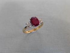ruby and diamond trilogy ring. Oval cut ( treated ) ruby weighing 2.40ct with a brilliant cut
