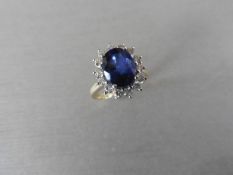 2.40ct sapphire and diamond cluster ring set with a oval cut(glass filled) sapphire which is