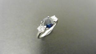Platinum trilogy style ring. Round-cut sapphire, 6mm in centre (treated) 2 brilliant cut diamonds.