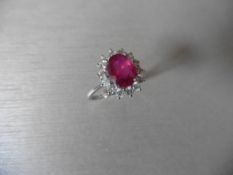 2.50ct Ruby and diamond cluster ring set with an oval cut ( glass filled )ruby which is surrounded