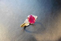 0.80ct ruby and diamond dress ring. 7x 5mm oval cutr uby (treated) with 3 small diamonds set