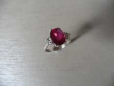 2.50ct 18ct white gold ruby and diamond dress ring set with an oval cut ( glass filled ) ruby