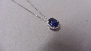 0.80ct halo set diamond pendant. Oval cut sapphire ( glass filled ) in the centre, 0.80ct, with a