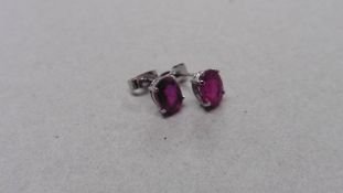 1.60ct ruby stud style earrings set in 9ct white gold. 7x5mm oval cut rubies (glass filled) .