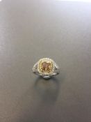 1.15ct diamond set solitaire ring with a yellow cushion cut yellow diamond and a halo setting and