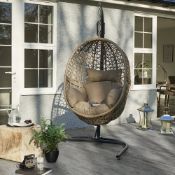The Hove rattan pod chair with cushions and stand is ideal for whiling away the hours, relaxing in