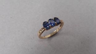 9ct yellow gold trilogy ring with 3 oval cut sapphires. 4 claw setting with open shoulders. Ring