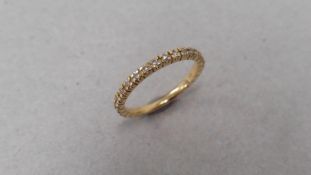 Diamond set band ring set in 18ct yellow gold. Brilliant cut diamonds set all the way round weighing