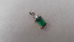9ct gold emerald and diamond pendant. Emerald cut ( treated ) emerald weighing approx1ct. Small