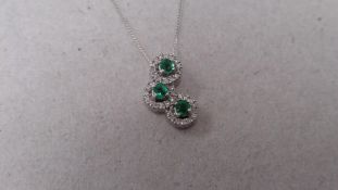 18ct white gold emerald and diamond trilogy style pendant. 3 round cut ( treated ) emeralds with a