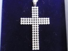 A diamond set cross pendant on chain