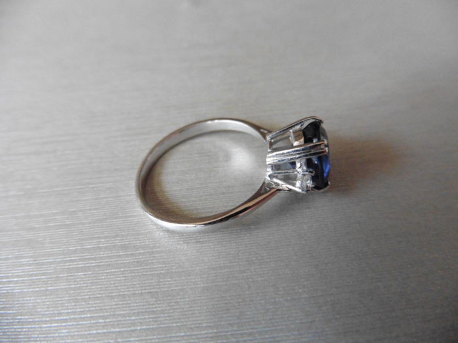 2.40ct sapphire and diamond ring. Oval cut ( glass filled ) sapphire with 2 small brilliant cut - Image 3 of 3