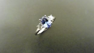 0.80ct tanzanite and diamond trilogy ring. 7x 5mm oval cut tanzanite (treated) with a small
