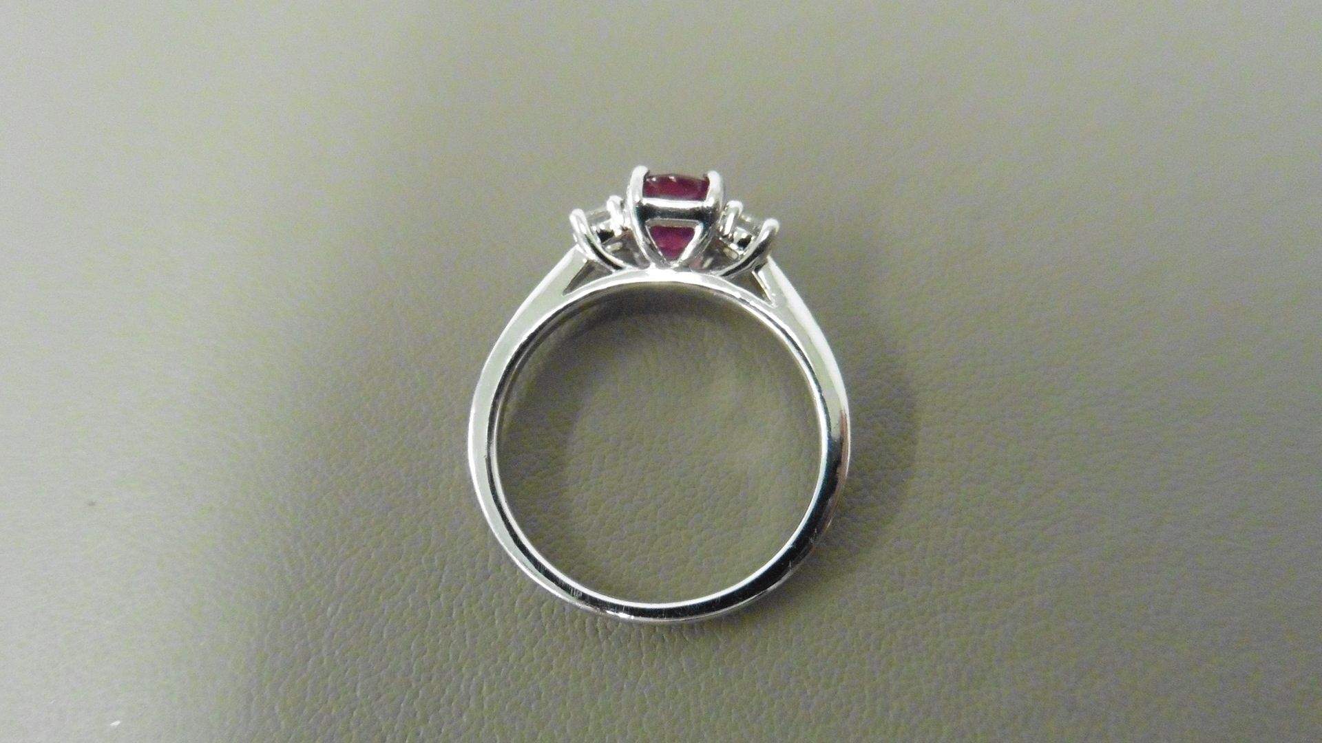 0.80ct ruby and diamond trilogy ring. 7x 5mm oval cut ruby ( glass filled) with a small diamond - Image 2 of 4