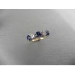 Sapphire and diamond five stone ring. 3 round cut sapphires ( treated ) 3.5mm and 2 brilliant cut