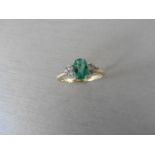 0.80ct emerald and diamond dress ring. 7x 5mm oval cut emerald (treated) with 3 small diamonds set