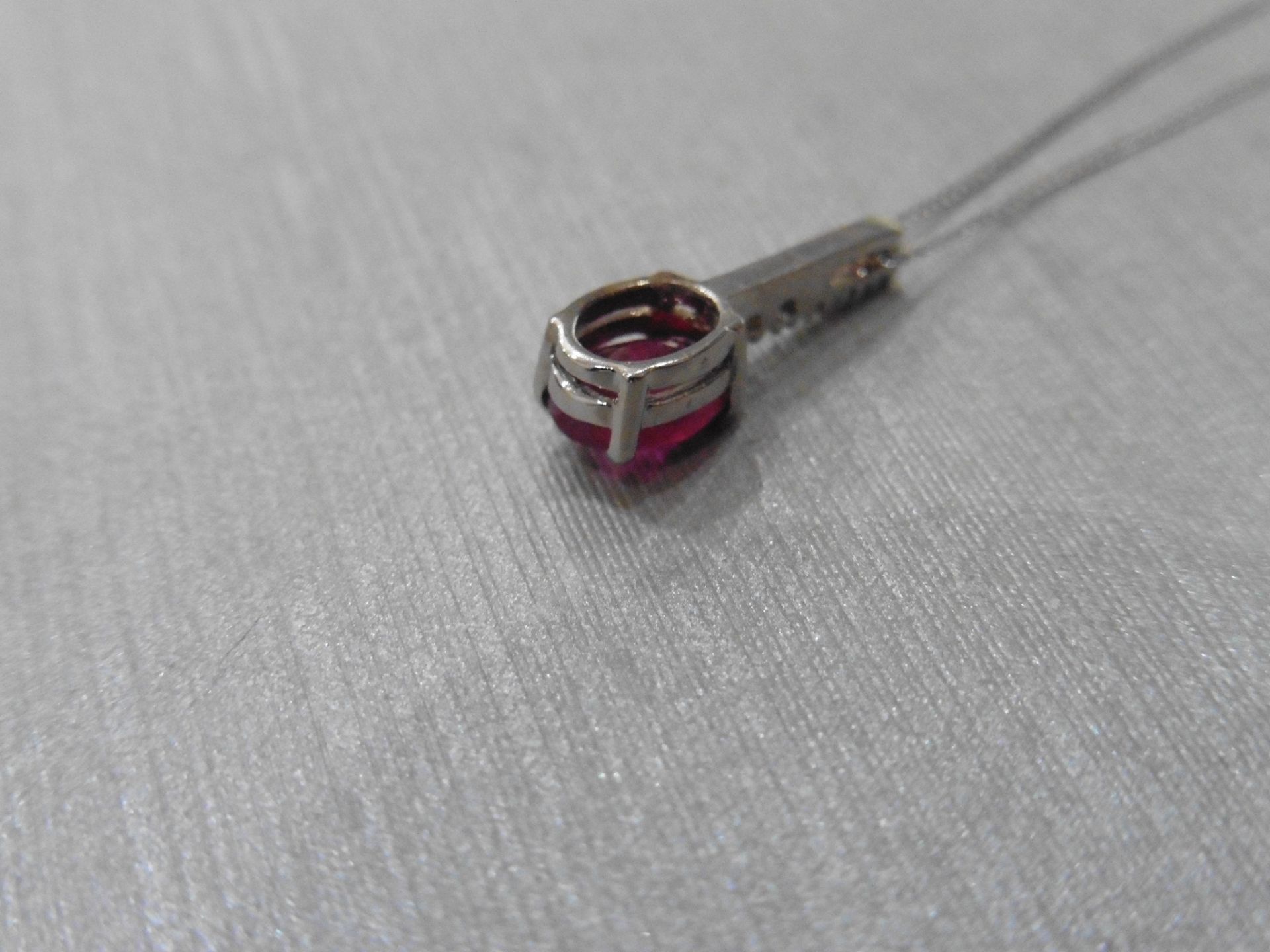 0.80ct Ruby and diamond drop style pendant. 7X 5mm oval ruby set with 5 small brilliant cut - Image 3 of 3