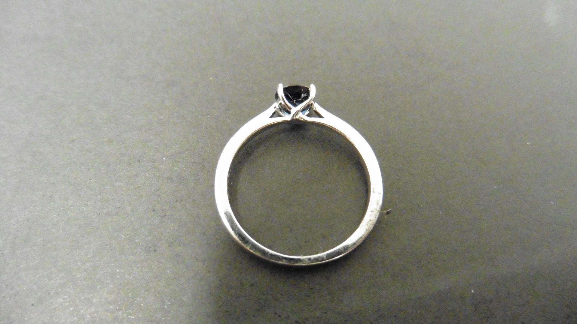 0.50ct solitaire style ring set with a round cut sapphire ( treated ) 5mm. Set in platinum with 4 - Image 2 of 4