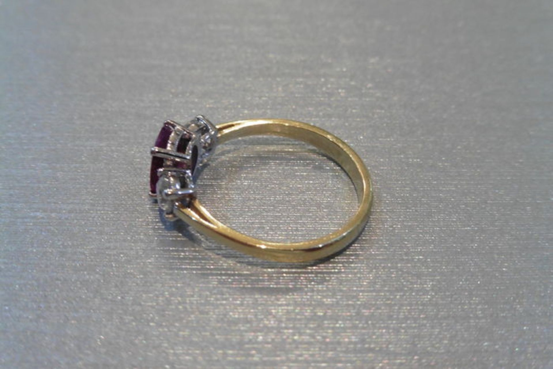 Ruby and diamond trilogy ring. Oval cut ( glass filled ) ruby weighing 2.40ct with a brilliant cut - Image 3 of 3