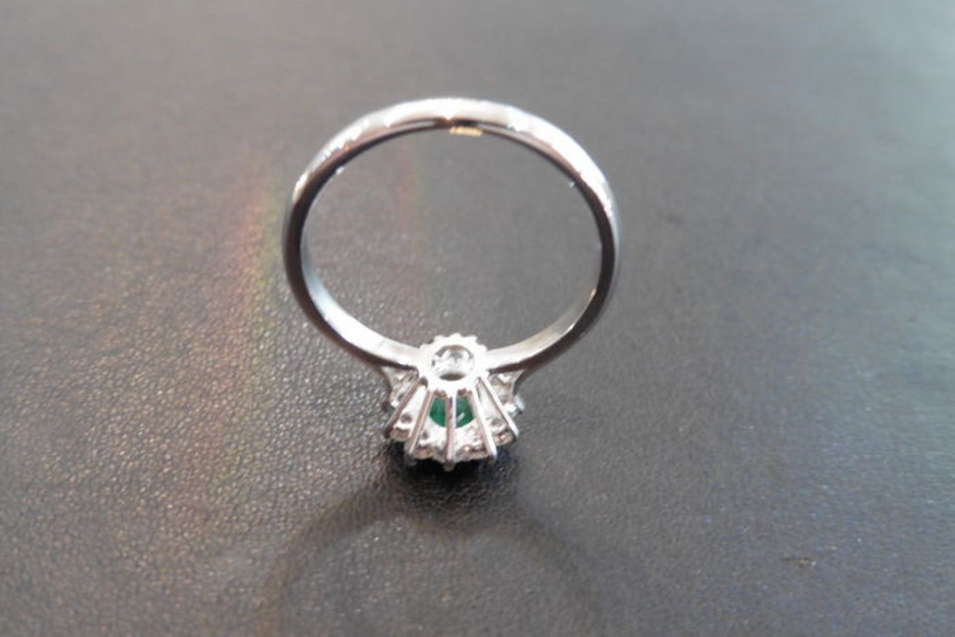 0.80ct emerald and diamond cluster ring set with a oval cut( treated) emerald which is surrounded by - Image 3 of 3