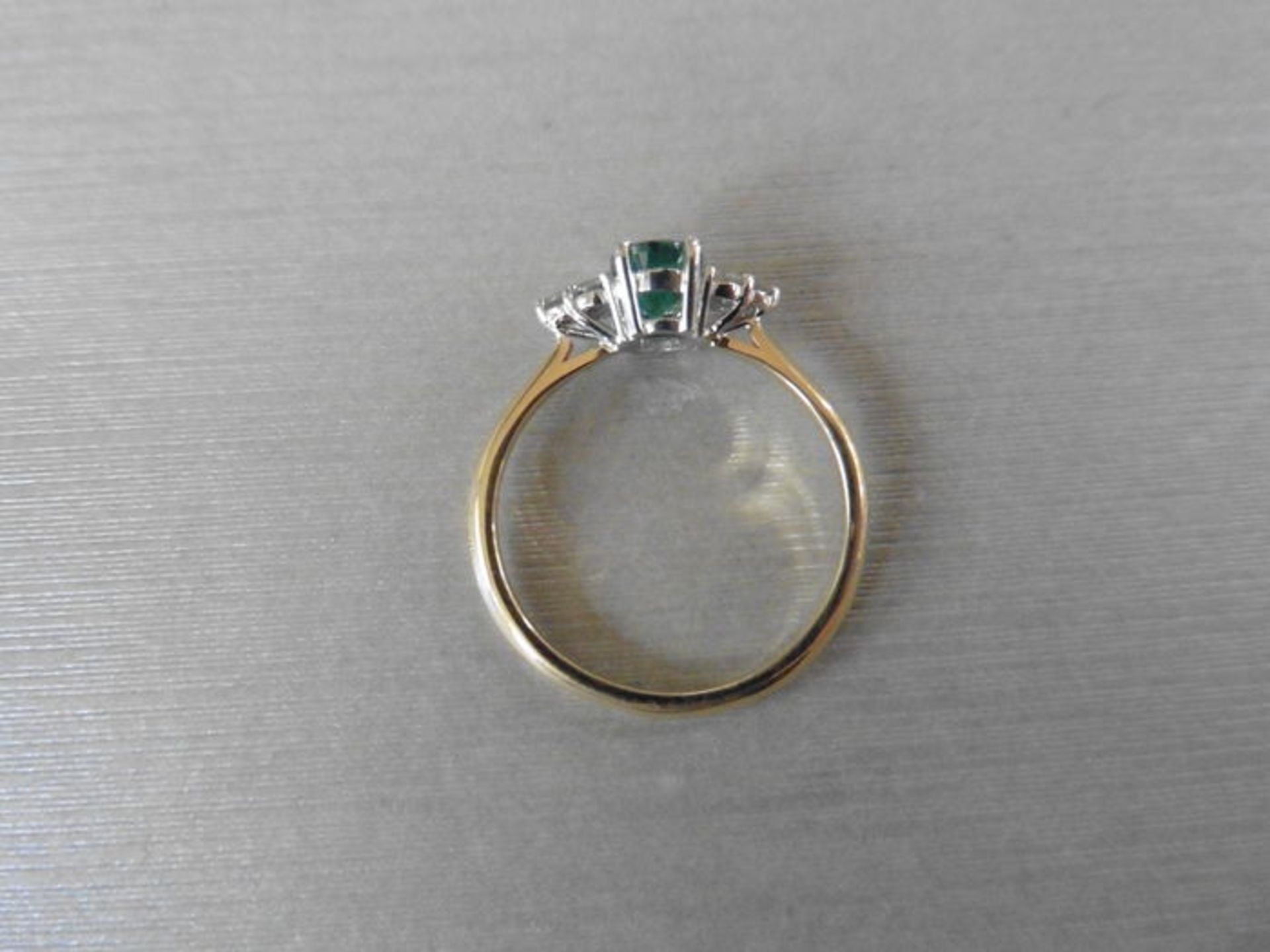 0.80ct emerald and diamond dress ring. 7x 5mm oval cut emerald (treated) with 3 small diamonds set - Image 2 of 3