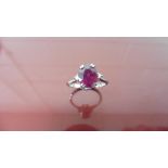 2.40ct Ruby and diamond dress ring. Oval cut ( glass filled ) ruby with a small brilliant cut