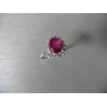 2.50ct Ruby and diamond cluster ring set with an oval cut (glass filled ) ruby which is surrounded