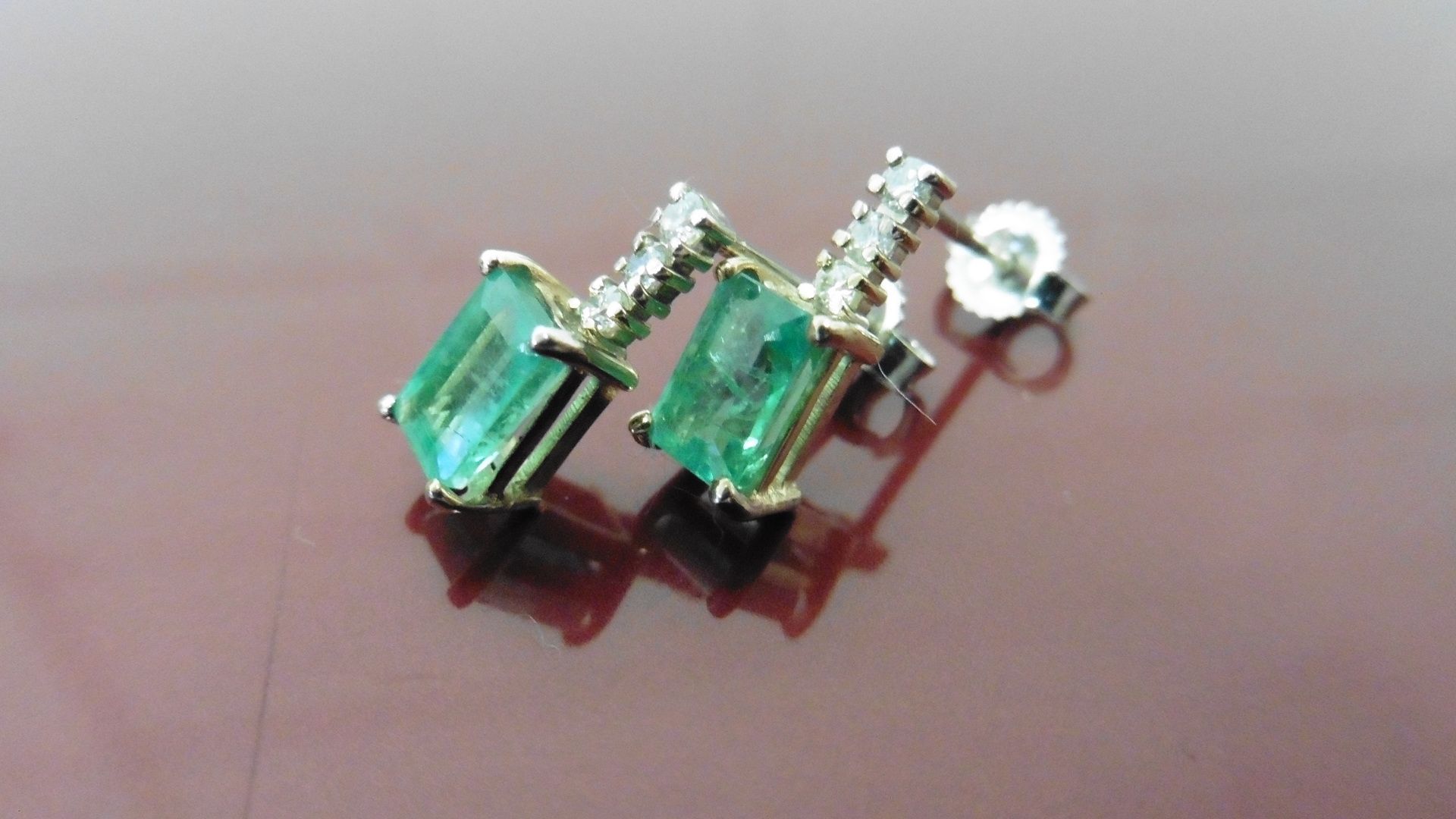 Emerald and diamond drop style earrings each set with an rectangular cut emerald, 6x4mm, weighing - Image 3 of 3