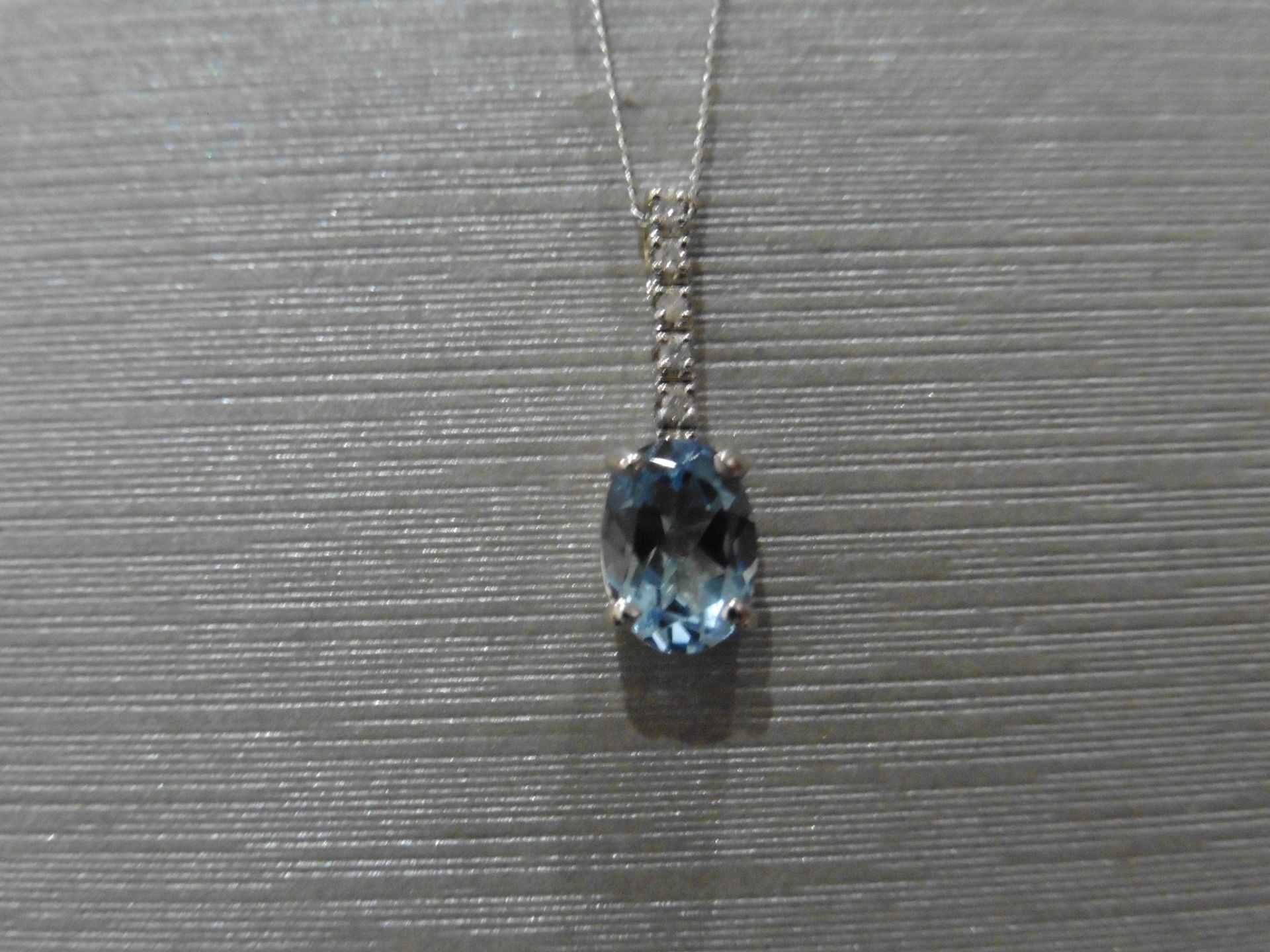 0.80ct Aqua marine and diamond drop style pendant. 7X 5mm oval aqua set with 5 small brilliant cut