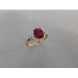 Ruby and diamond trilogy ring. Oval cut ( glass filled ) ruby weighing 2.40ct with a brilliant cut