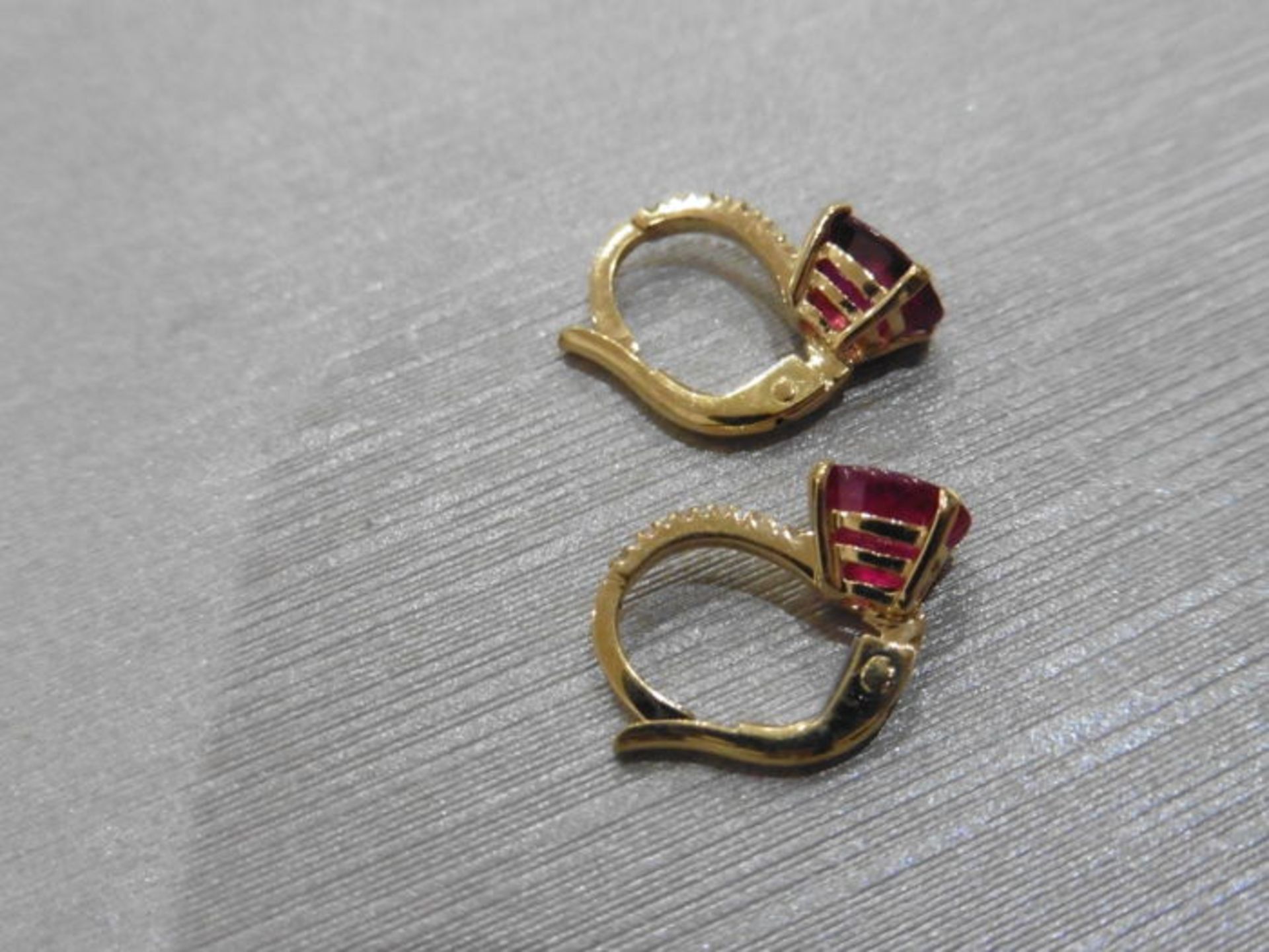 1.60ct Ruby and diamond hoop style earrings. Each is set with a 7x 5mm oval cut Ruby ( treated ) - Image 2 of 2