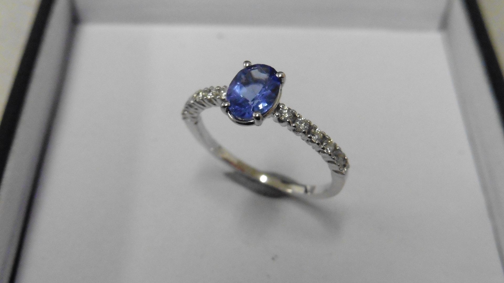 0.80ct / 0.12ct tanzanite and diamond dress ring. Oval cut ( treated ) tanzanite with small diamonds